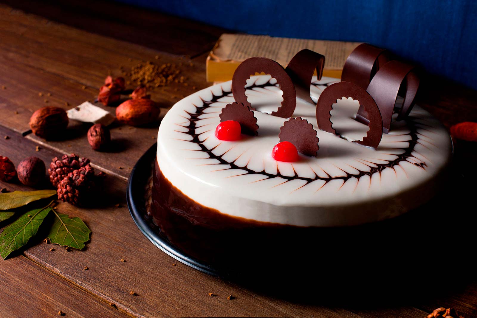 Pastel diablo de Lecaroz, decorado con ganache blanco y negro, chocolate oscuro y cerezas