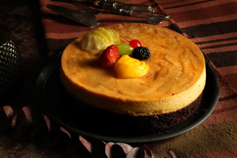 Flan imposible de Lecaroz, decorado con cereza, zarzamora uva, fresas, manzana y durazno en almíbar